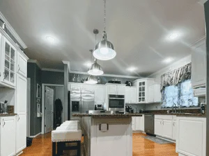 White painted kitchen ceiling with recessed lights, white trim, and painted walls