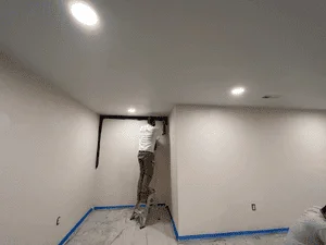 Interior room with taped drywall, primed walls, and recessed ceiling lights