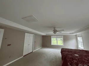 Interior room with taupe walls, white trim, and painted ceiling with ceiling fan