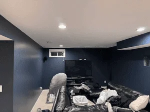 Basement with navy blue painted walls, white trim, and recessed ceiling lights