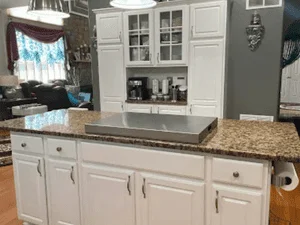 White painted kitchen cabinets with granite countertop and hardware