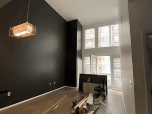 Charcoal accent wall with white trim and window, interior room painting project