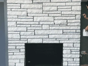 White painted brick fireplace with black firebox opening and clean paint lines