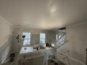 Interior room with finished drywall, taped seams, and primed ceiling and walls